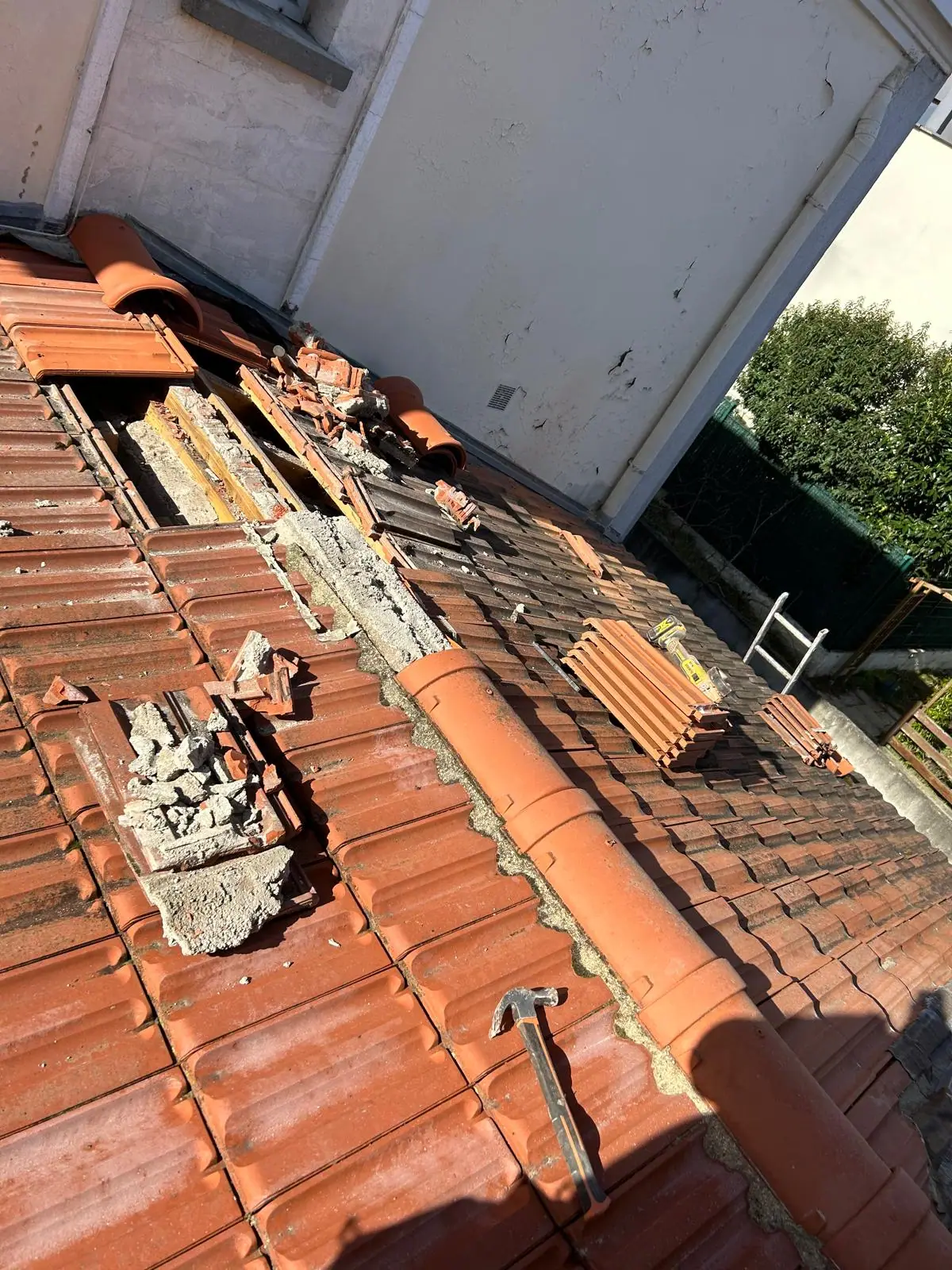 Rive de toiture en cours de dépose, ancien mortier de scellement cassé et tuiles de rive retirées — RW Couvreur